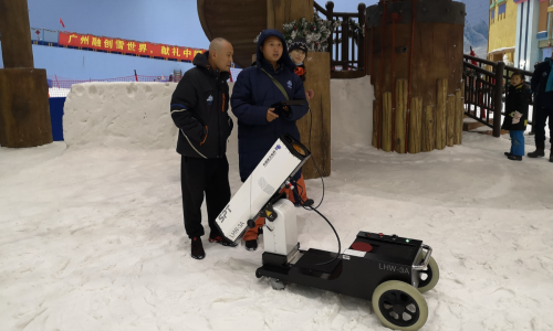 Staffs operate CO₂ laser obstacle remover at an indoor ice resort